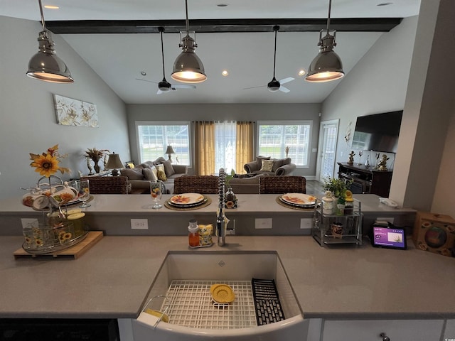 kitchen with open floor plan, a sink, ceiling fan, and beam ceiling