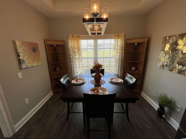 dining area with baseboards, a notable chandelier, and wood finished floors