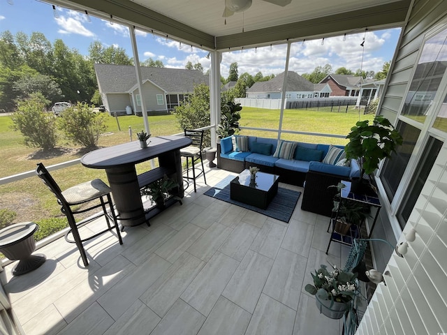 view of patio with fence, a residential view, an outdoor living space, and a ceiling fan