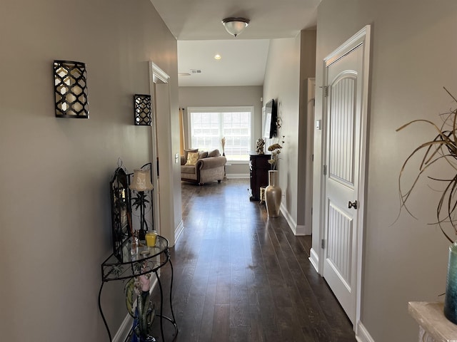 hallway with baseboards and dark wood-style floors