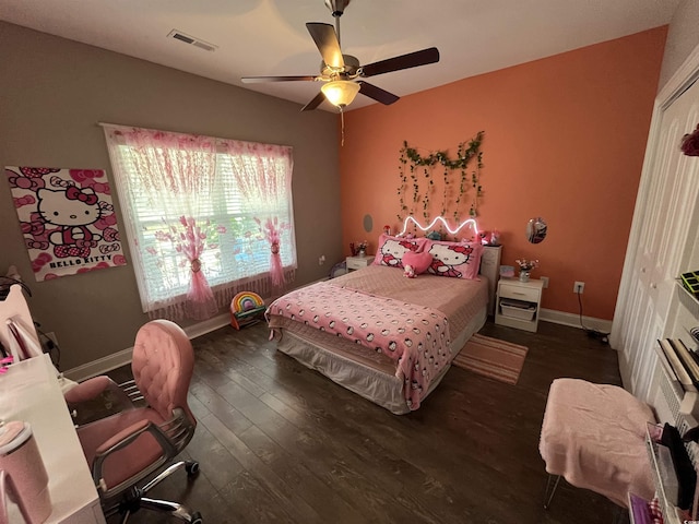 bedroom with ceiling fan, baseboards, visible vents, and wood finished floors