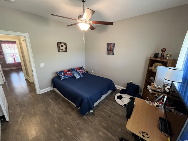 bedroom featuring baseboards, ceiling fan, and wood finished floors