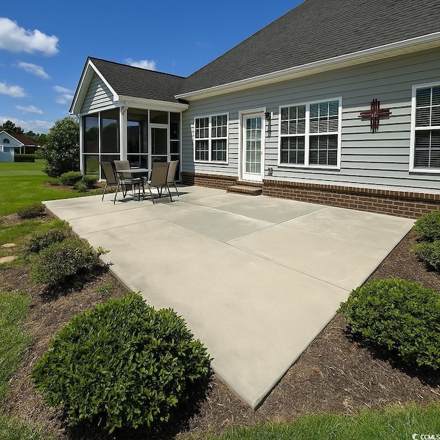 rear view of property with a sunroom, entry steps, and a patio