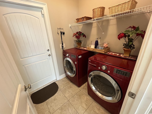 laundry area with laundry area, light tile patterned floors, and washer and dryer