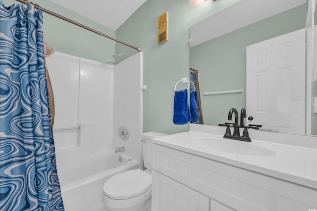 bathroom featuring vanity, shower / tub combo, and toilet