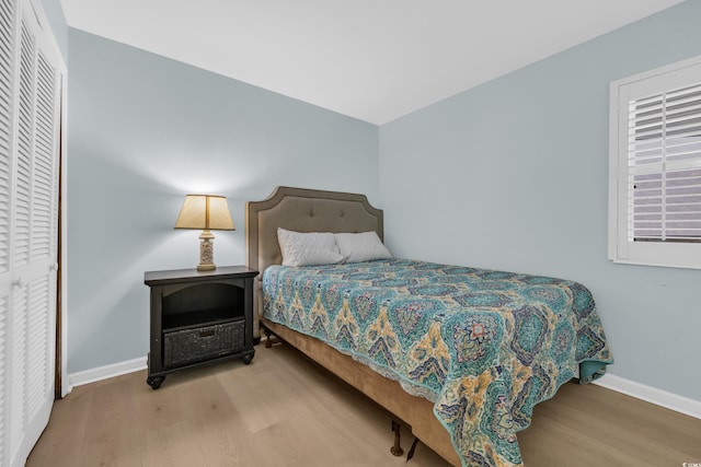 bedroom featuring baseboards and wood finished floors