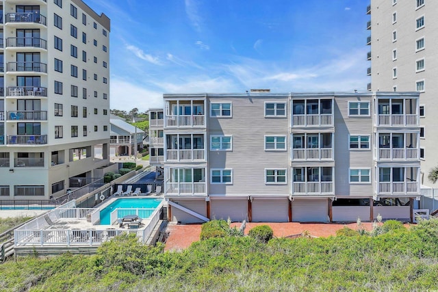 view of building exterior featuring a community pool
