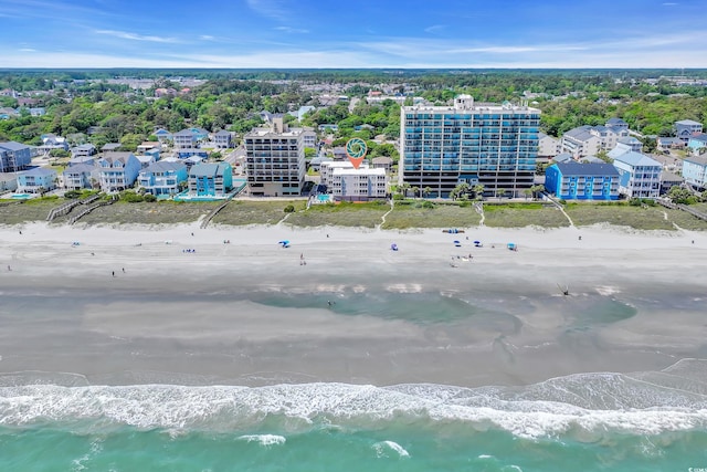 bird's eye view featuring a water view and a beach view
