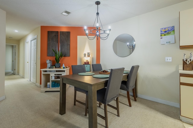 dining room with a notable chandelier, light colored carpet, baseboards, and visible vents