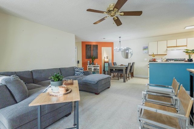 living area featuring ceiling fan with notable chandelier and light carpet