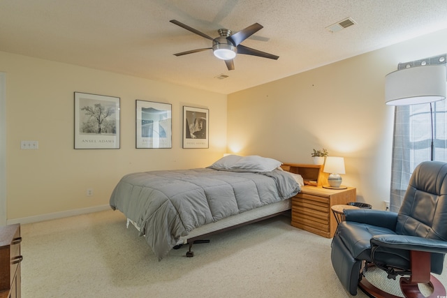 bedroom with light colored carpet, a ceiling fan, baseboards, and visible vents