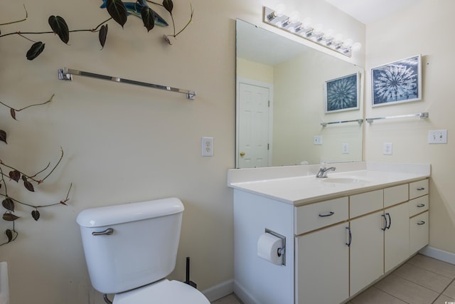 bathroom with baseboards, tile patterned floors, vanity, and toilet