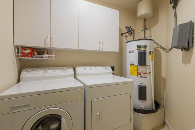 washroom featuring water heater, cabinet space, and washer and clothes dryer
