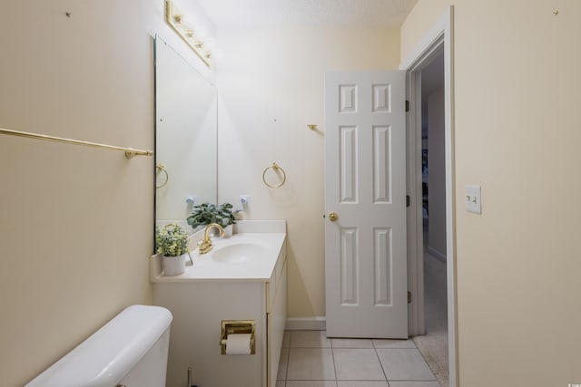 half bathroom with tile patterned floors, vanity, and toilet