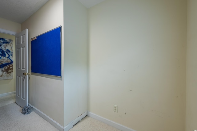 interior space with carpet floors and baseboards