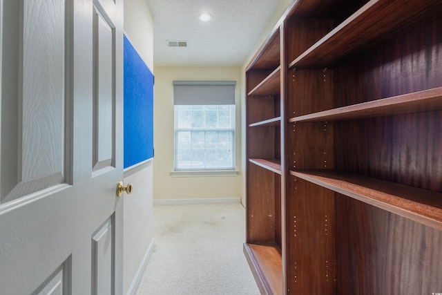 walk in closet featuring carpet floors and visible vents