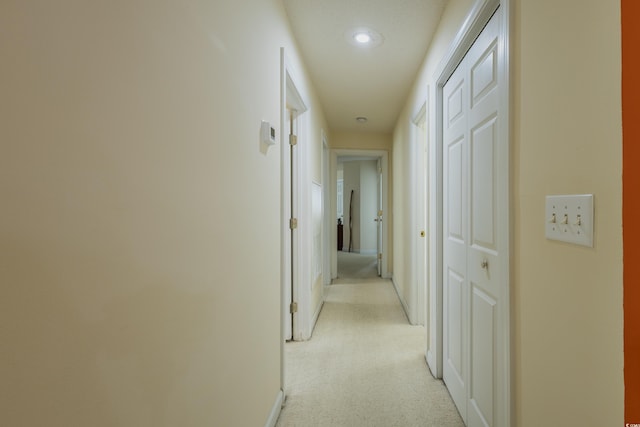 hall with recessed lighting, baseboards, and light carpet