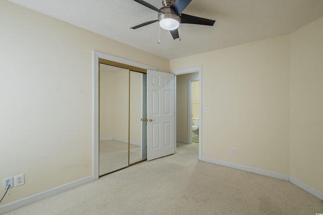unfurnished bedroom with a ceiling fan, baseboards, carpet, and a closet