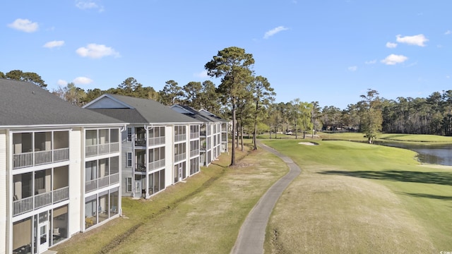 view of home's community with a water view and view of golf course