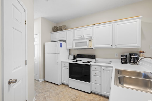 kitchen with white appliances, white cabinetry, a sink, and light countertops