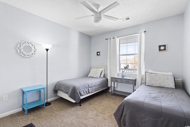 carpeted bedroom featuring baseboards, visible vents, and ceiling fan