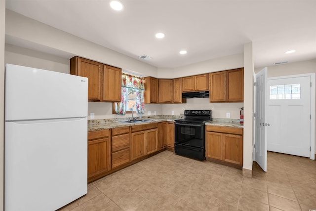 1361 Turkey Ridge Rd Unit C, Surfside Beach, SC 29575 - kitchen with freestanding refrigerator, black electric range, a sink, brown cabinets, and under cabinet range hood