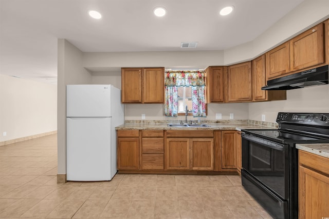 1361 Turkey Ridge Rd Unit C, Surfside Beach, SC 29575 - kitchen featuring black electric range oven, freestanding refrigerator, a sink, under cabinet range hood, and brown cabinets