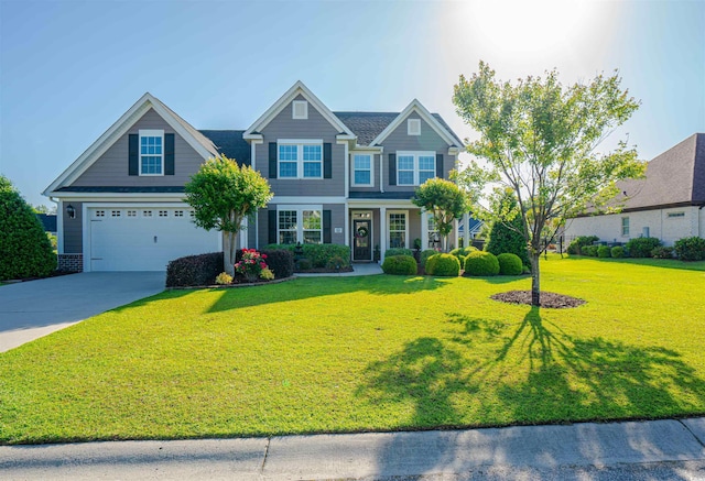 craftsman-style home featuring a garage, concrete driveway, and a front yard