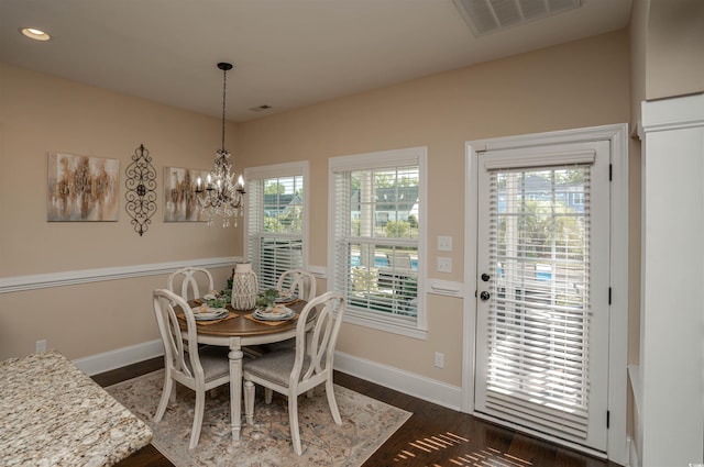 dining space with a chandelier, dark wood finished floors, recessed lighting, baseboards, and visible vents