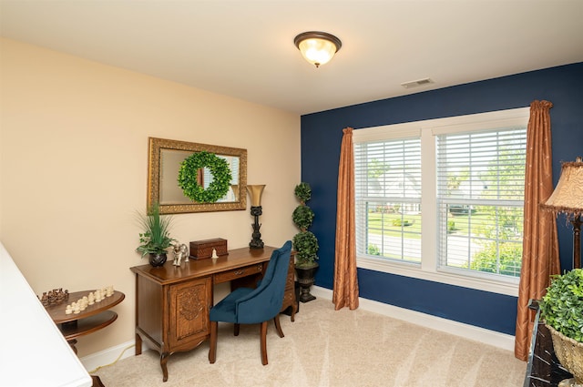 office featuring baseboards, visible vents, and light carpet