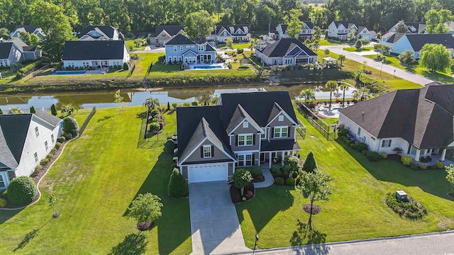 drone / aerial view with a water view and a residential view