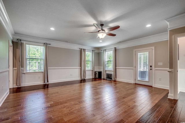 empty room with a ceiling fan, a textured ceiling, and a healthy amount of sunlight