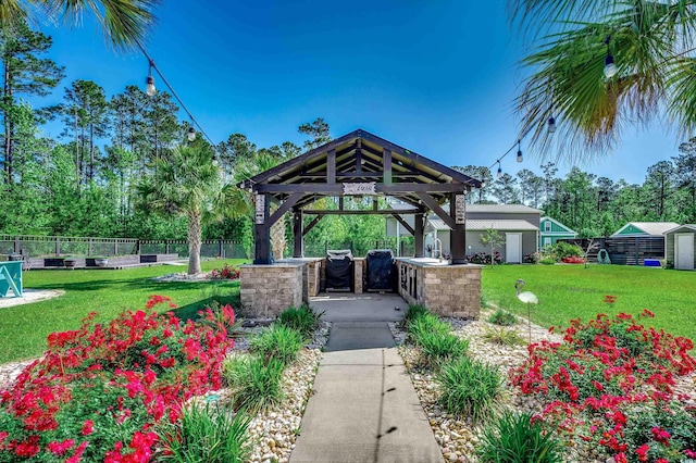 view of property's community featuring a gazebo, fence, and a yard