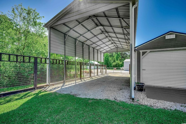 view of outdoor structure with fence, a detached carport, and an outdoor structure