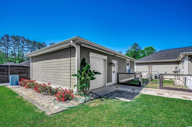 view of outbuilding featuring fence, a gate, and a garage