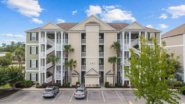 view of apartment building / complex featuring uncovered parking