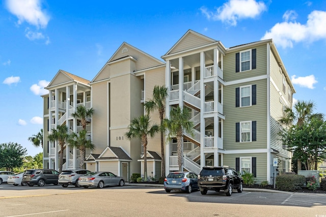 view of apartment building / complex with uncovered parking