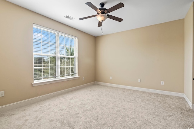 carpeted spare room with baseboards and ceiling fan