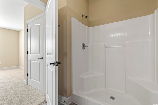 full bathroom with a shower and baseboards