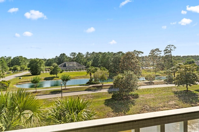 view of community featuring a water view and a lawn