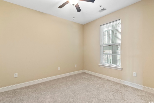 unfurnished room featuring carpet flooring, a ceiling fan, and baseboards