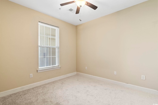 unfurnished room featuring a ceiling fan, carpet floors, and baseboards