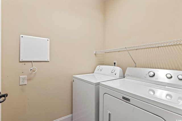 clothes washing area with separate washer and dryer