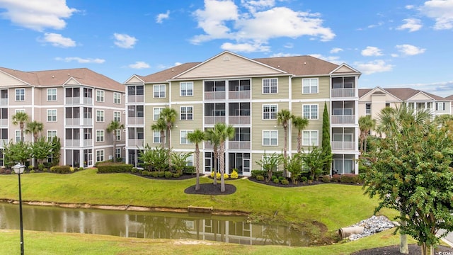 view of apartment building / complex featuring a water view