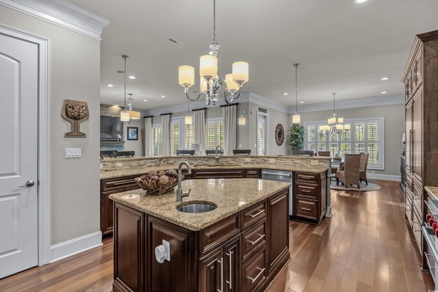 256 Shoreward Dr, Myrtle Beach, SC 29579 - kitchen featuring dark wood-style flooring, a sink, baseboards, a chandelier, and an island with sink