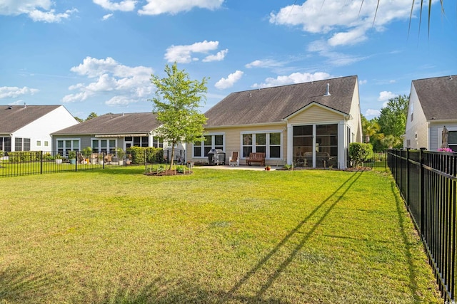 2446 Craven Dr, Myrtle Beach, SC 29572 - rear view of property featuring a fenced backyard, a sunroom, a yard, and a patio area