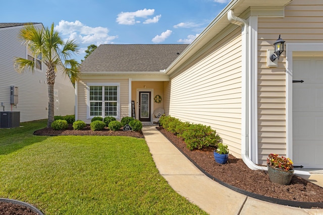 2446 Craven Dr, Myrtle Beach, SC 29572 - doorway to property with a lawn, a garage, central AC, and a shingled roof