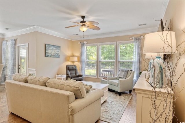 2446 Craven Dr, Myrtle Beach, SC 29572 - living room with ceiling fan, ornamental molding, light wood-style flooring, and visible vents