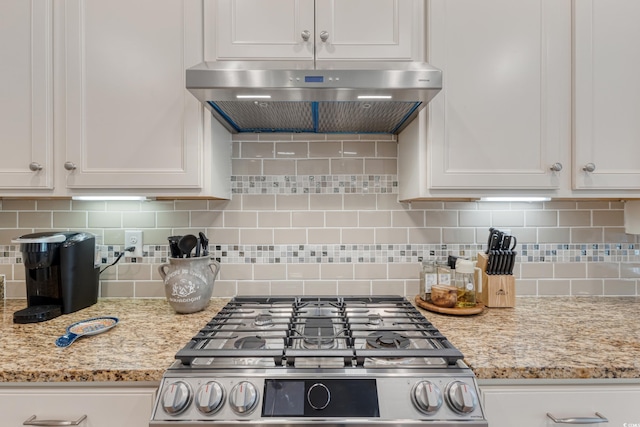 2446 Craven Dr, Myrtle Beach, SC 29572 - kitchen with gas range, ventilation hood, light stone countertops, and white cabinets