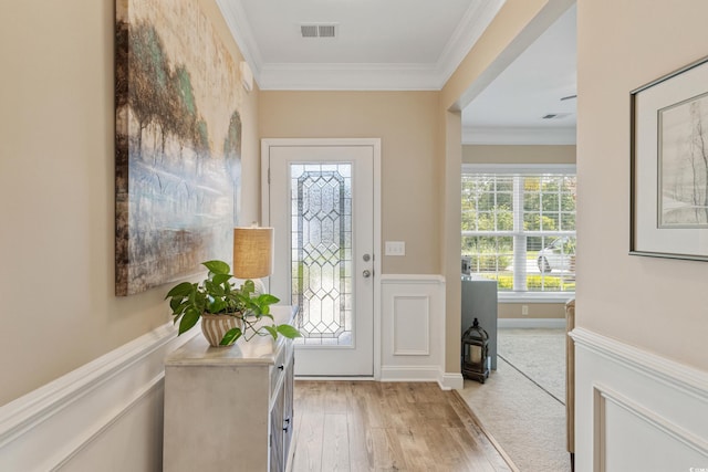 2446 Craven Dr, Myrtle Beach, SC 29572 - doorway to outside with visible vents, light wood-style flooring, crown molding, and a wainscoted wall